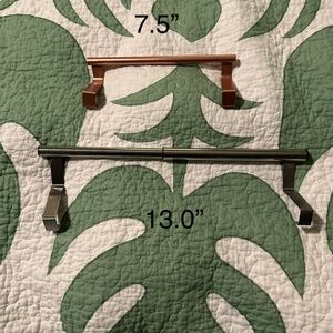 Two over the cabinet towel bars.  Copper and steel.